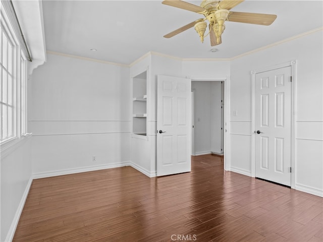 unfurnished bedroom featuring wood-type flooring, crown molding, and ceiling fan