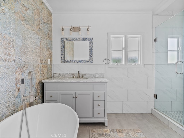 bathroom featuring shower with separate bathtub, tile walls, ornamental molding, and vanity