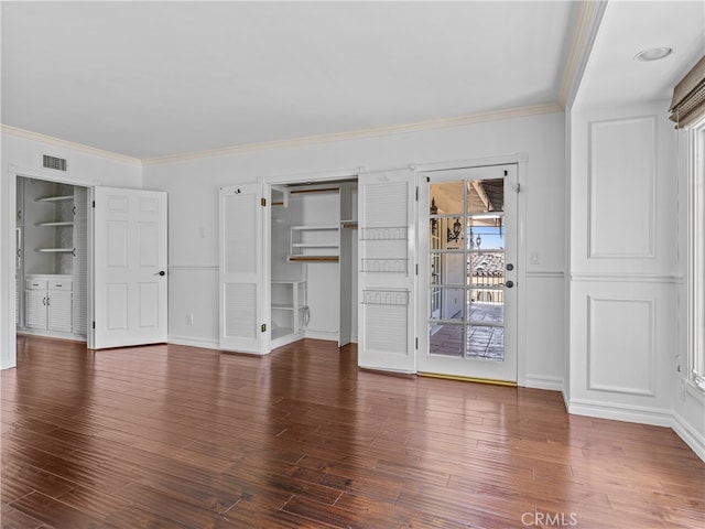 interior space featuring access to exterior, ornamental molding, and dark wood-type flooring