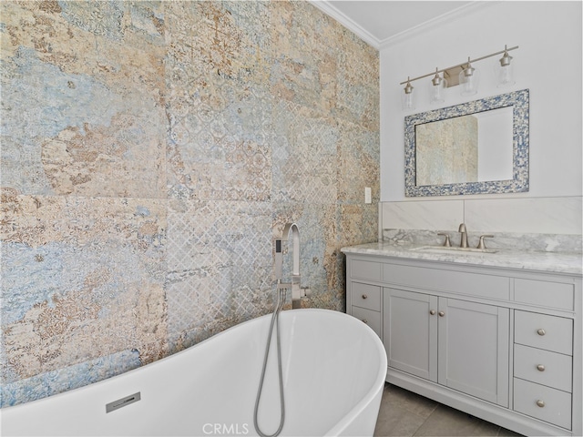 bathroom featuring tile walls, a bathing tub, vanity, tile patterned flooring, and ornamental molding