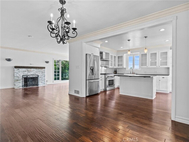 unfurnished living room with a fireplace, dark hardwood / wood-style floors, and a wealth of natural light