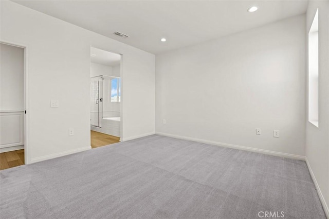 empty room with light colored carpet