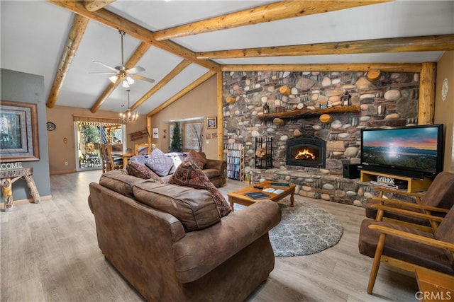 living room with ceiling fan with notable chandelier, light wood-type flooring, lofted ceiling with beams, and a fireplace