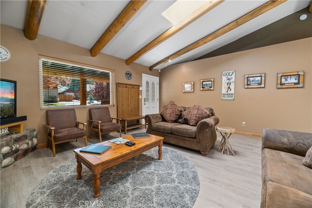 living room with lofted ceiling with beams and light hardwood / wood-style flooring