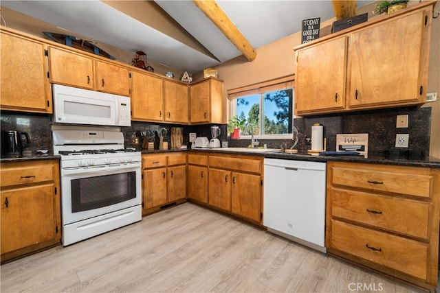 kitchen with white appliances, sink, light hardwood / wood-style flooring, and tasteful backsplash