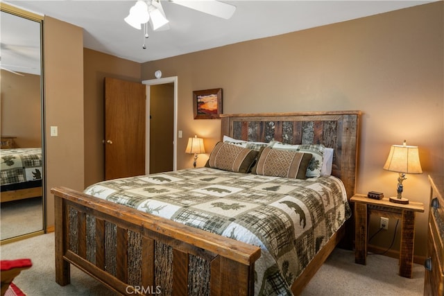 bedroom featuring light carpet, ceiling fan, and a closet