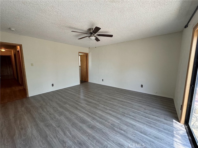 empty room with ceiling fan, a textured ceiling, and dark hardwood / wood-style floors