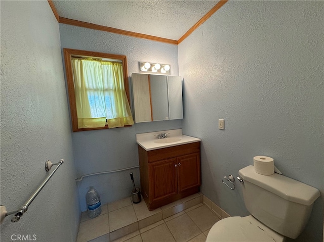 bathroom with tile patterned flooring, a textured ceiling, crown molding, vanity, and toilet