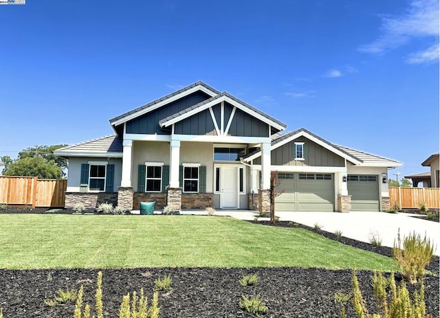 craftsman inspired home with a front yard and a garage