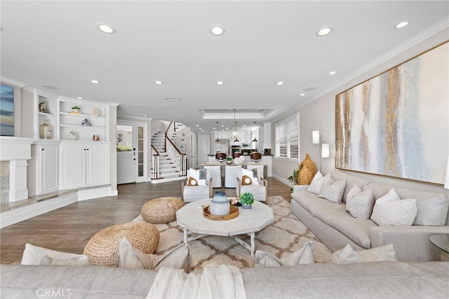 living room featuring hardwood / wood-style flooring and ornamental molding