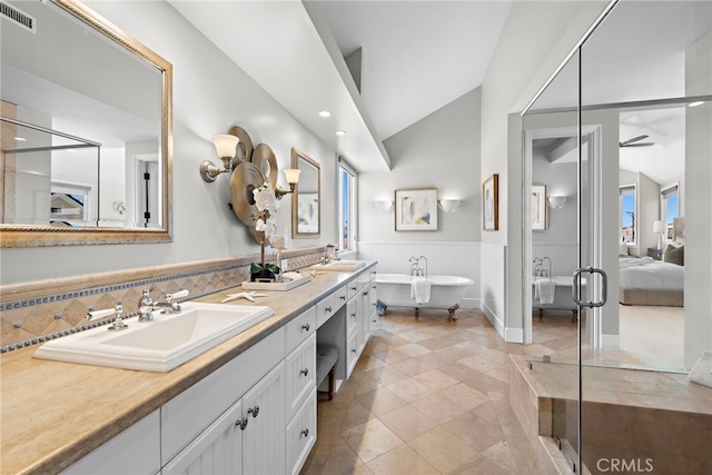 bathroom with ceiling fan, vanity, vaulted ceiling, tile patterned floors, and shower with separate bathtub