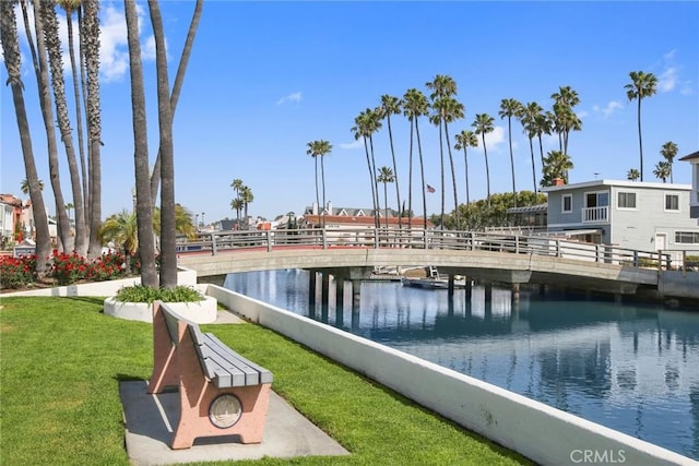 view of community featuring a water view and a lawn