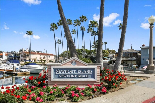 community / neighborhood sign featuring a water view