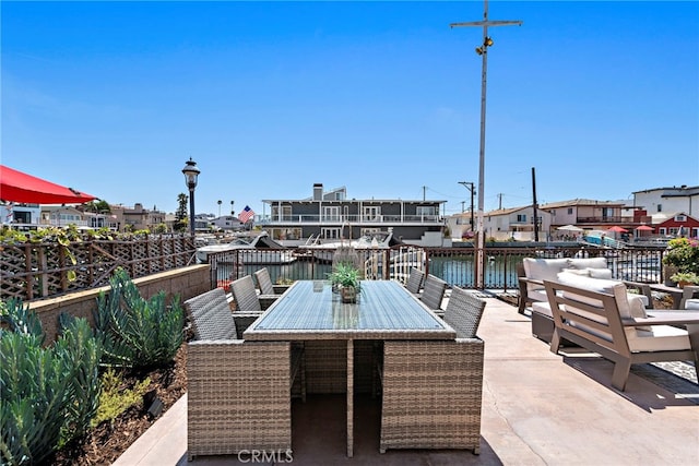 view of patio with a water view and an outdoor hangout area