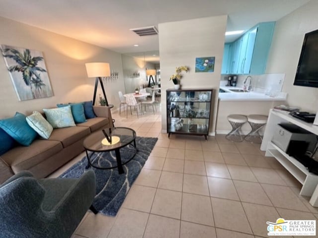 tiled living room featuring sink