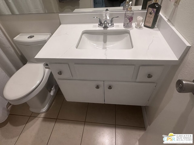 bathroom with vanity, tile patterned flooring, and toilet