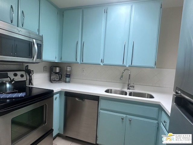 kitchen featuring stainless steel appliances, backsplash, and sink