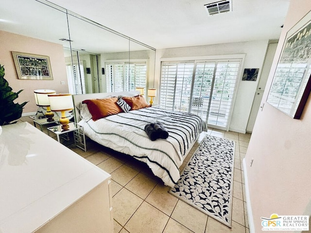 tiled bedroom featuring access to exterior