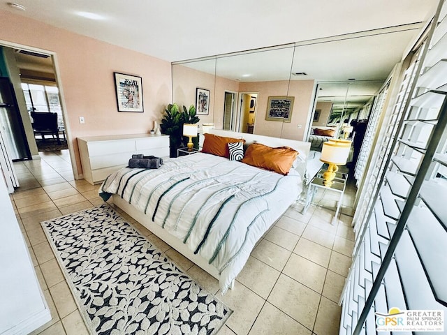 tiled bedroom with a closet