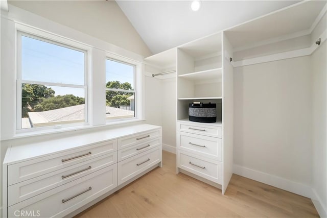 spacious closet with lofted ceiling and light hardwood / wood-style floors