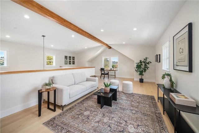 living room with lofted ceiling with beams and light wood-type flooring