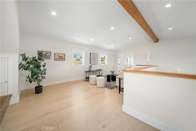 interior space featuring vaulted ceiling with beams and light hardwood / wood-style floors