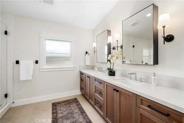 bathroom with tile patterned floors, a shower with shower door, and vanity