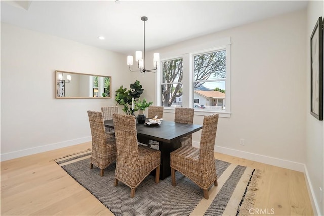 dining room featuring an inviting chandelier and light hardwood / wood-style floors