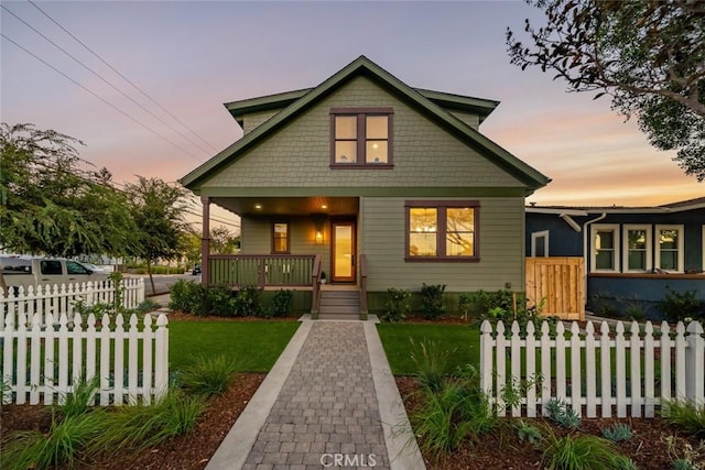 bungalow featuring a yard and a porch