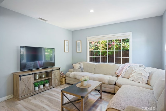 living room with light hardwood / wood-style flooring