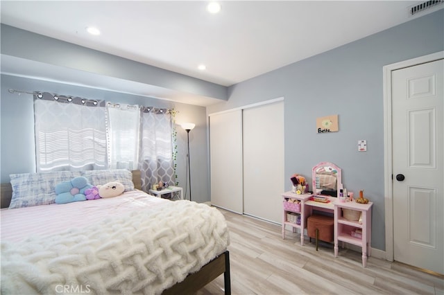 bedroom featuring a closet and light hardwood / wood-style floors