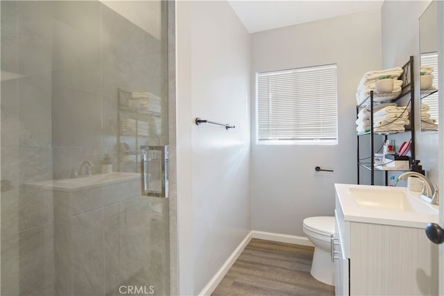 bathroom with vanity, hardwood / wood-style floors, toilet, and an enclosed shower