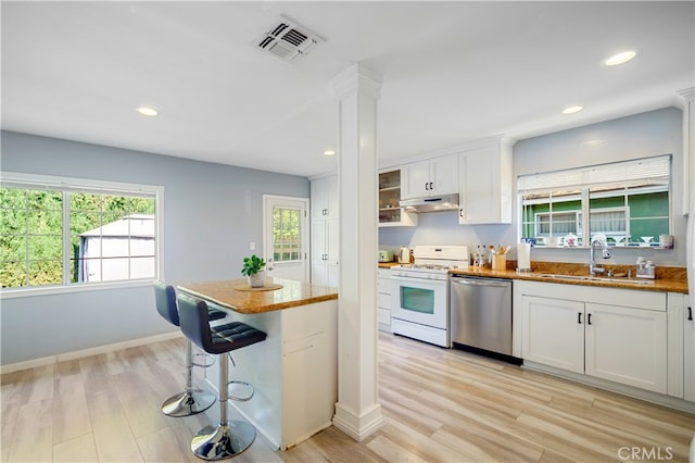 kitchen featuring white cabinets, dishwasher, white range oven, and sink