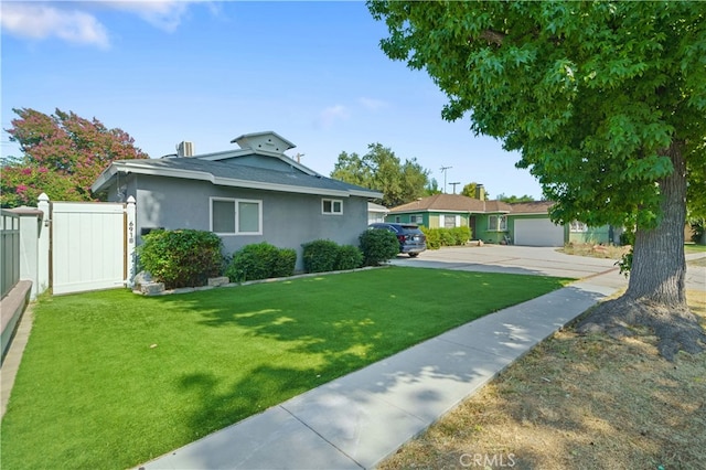 view of front of home with a garage and a front lawn