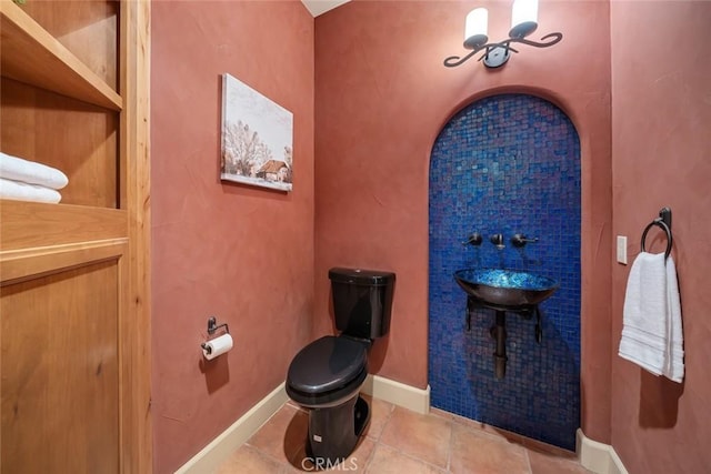 bathroom with tile patterned floors and toilet