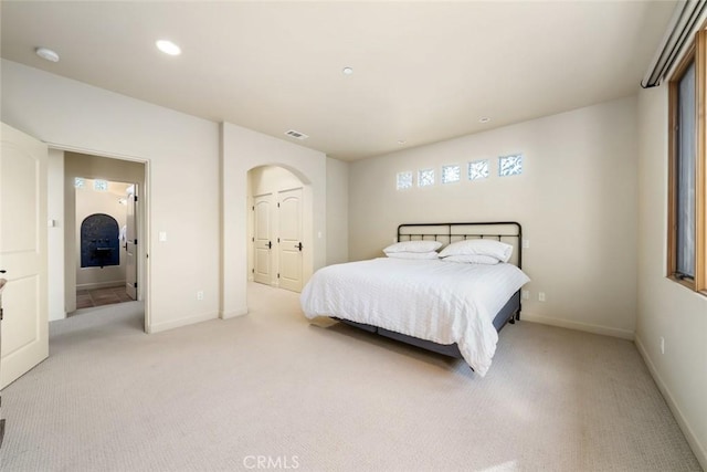 carpeted bedroom with ensuite bath