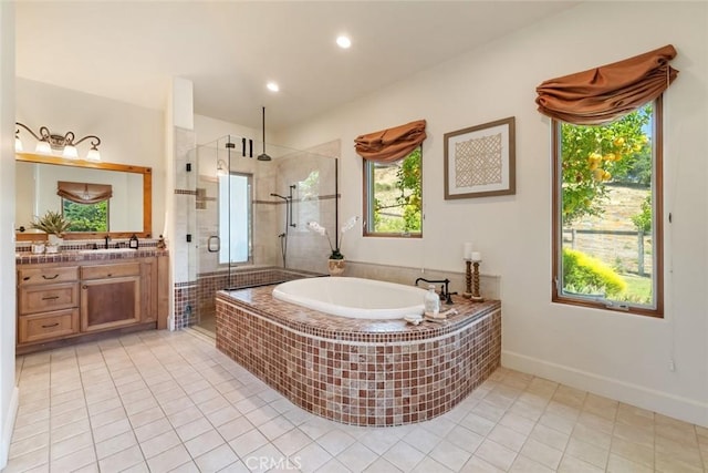 bathroom featuring tile patterned flooring, vanity, and shower with separate bathtub