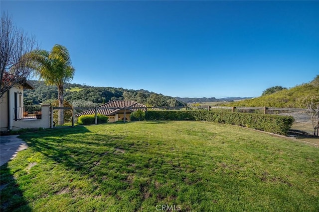 view of yard with a mountain view and a rural view