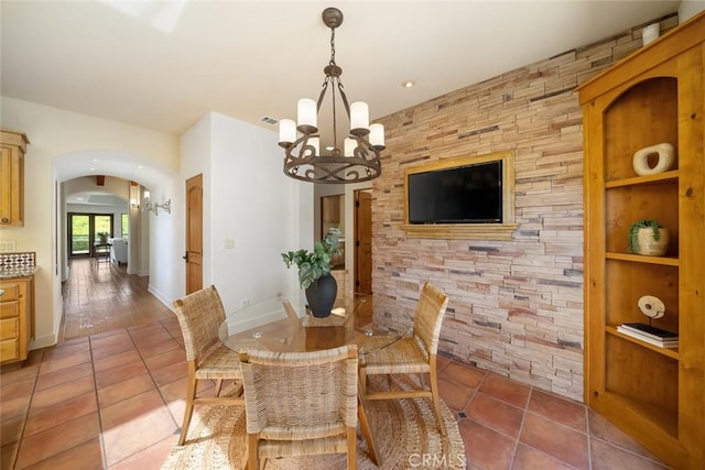 tiled dining space featuring a chandelier