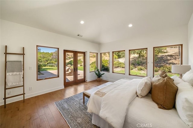 bedroom featuring access to exterior, french doors, and hardwood / wood-style flooring