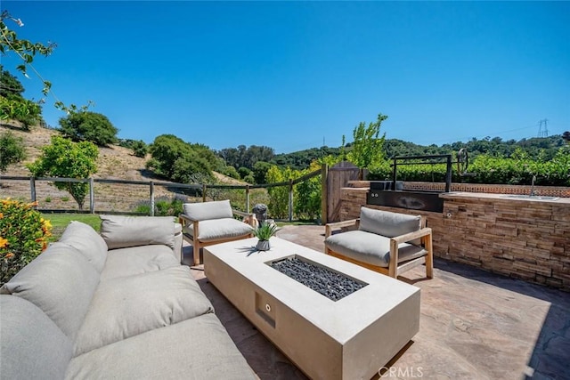 view of patio / terrace featuring sink and an outdoor fire pit