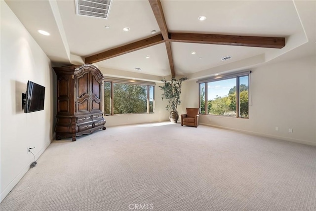 interior space with vaulted ceiling with beams, plenty of natural light, and light colored carpet