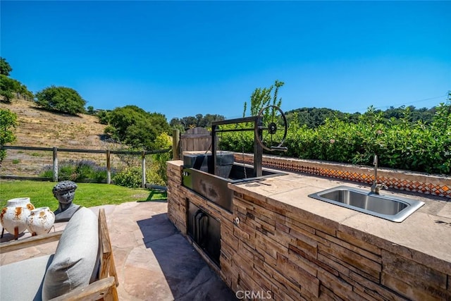 view of patio featuring sink and exterior kitchen