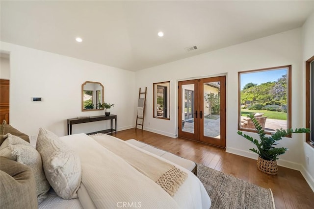 bedroom with wood-type flooring, access to outside, and french doors