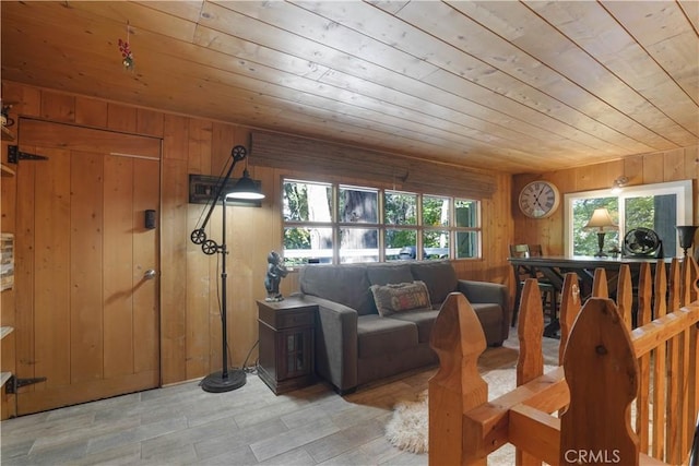 living room featuring wooden ceiling and wooden walls