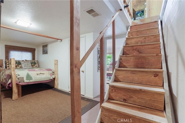 carpeted bedroom featuring a textured ceiling