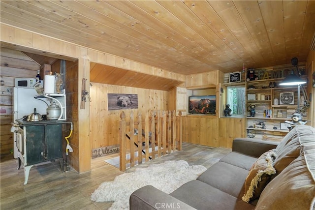 living room featuring wooden ceiling, hardwood / wood-style floors, and wooden walls