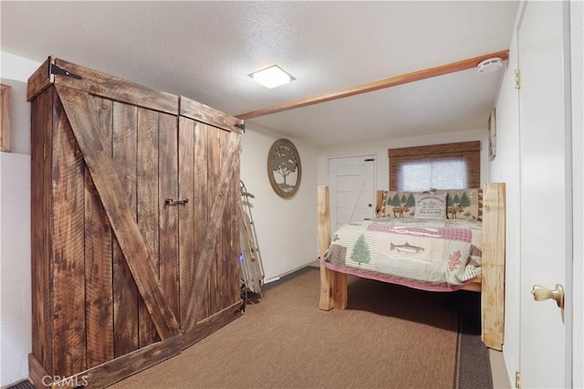 bedroom with a textured ceiling and light carpet