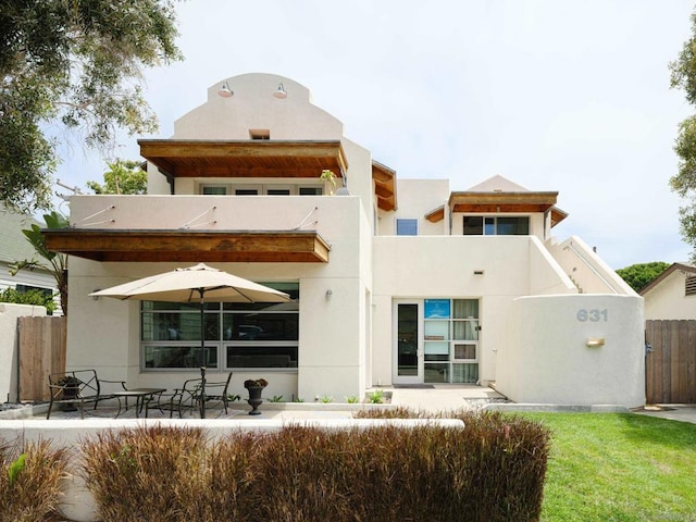 rear view of property with a yard and a patio