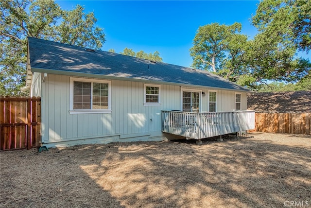 back of house featuring a wooden deck